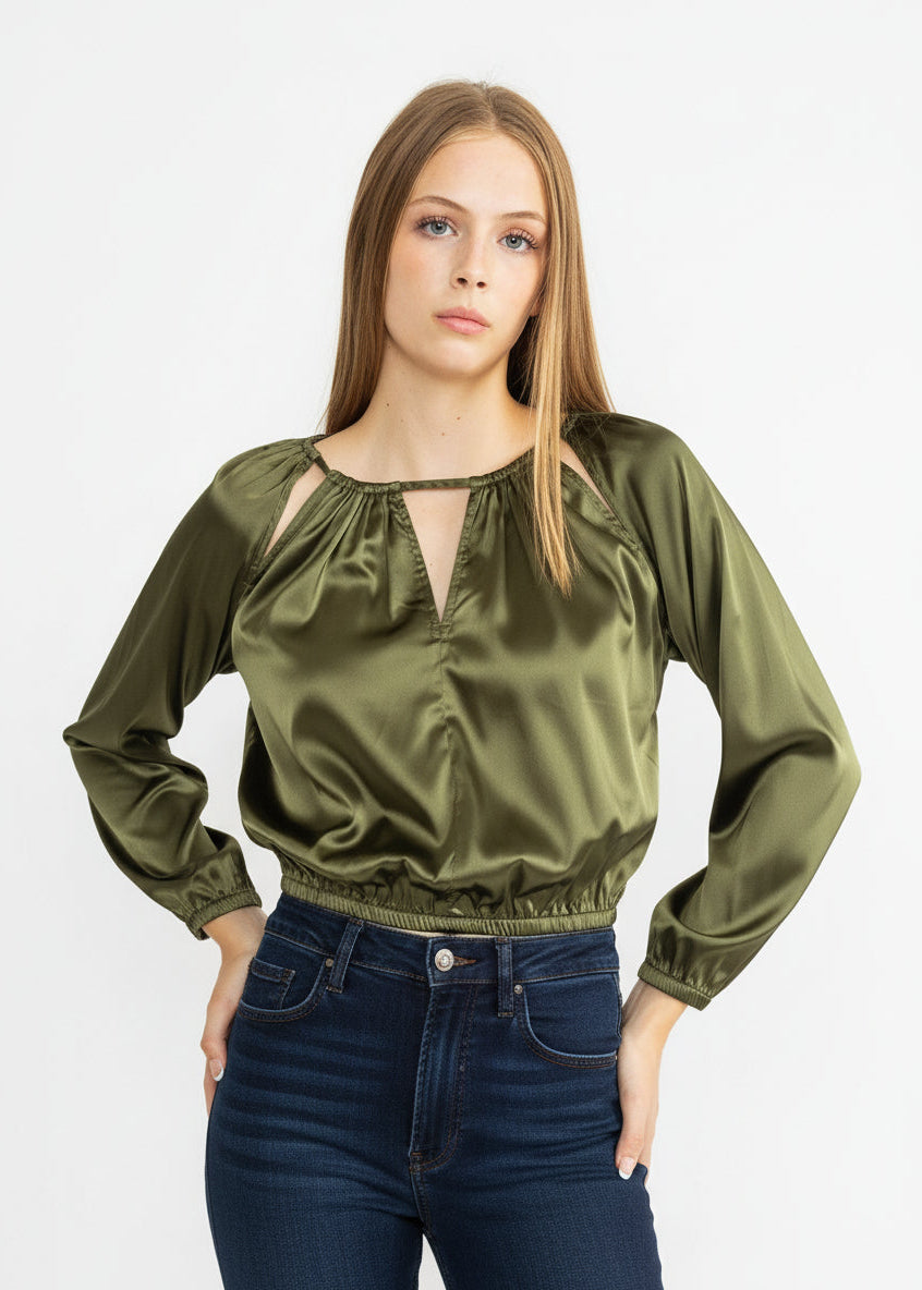 Woman wearing an olive green blouse with long sleeves and a V-neckline on a white background