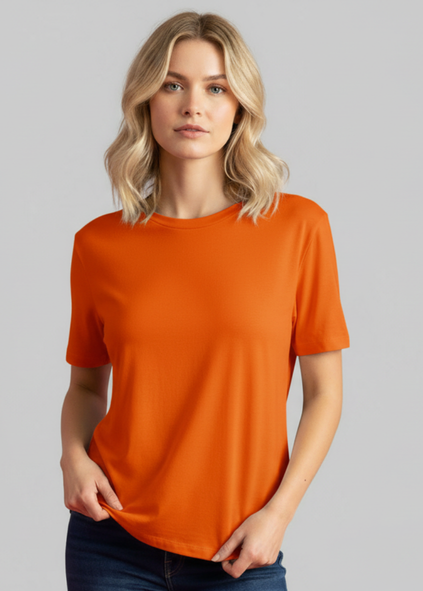 Woman wearing an orange t-shirt against a gray background
