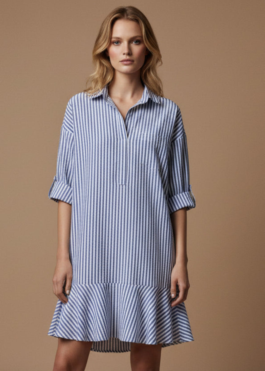 Woman wearing a blue and white striped dress against a brown background