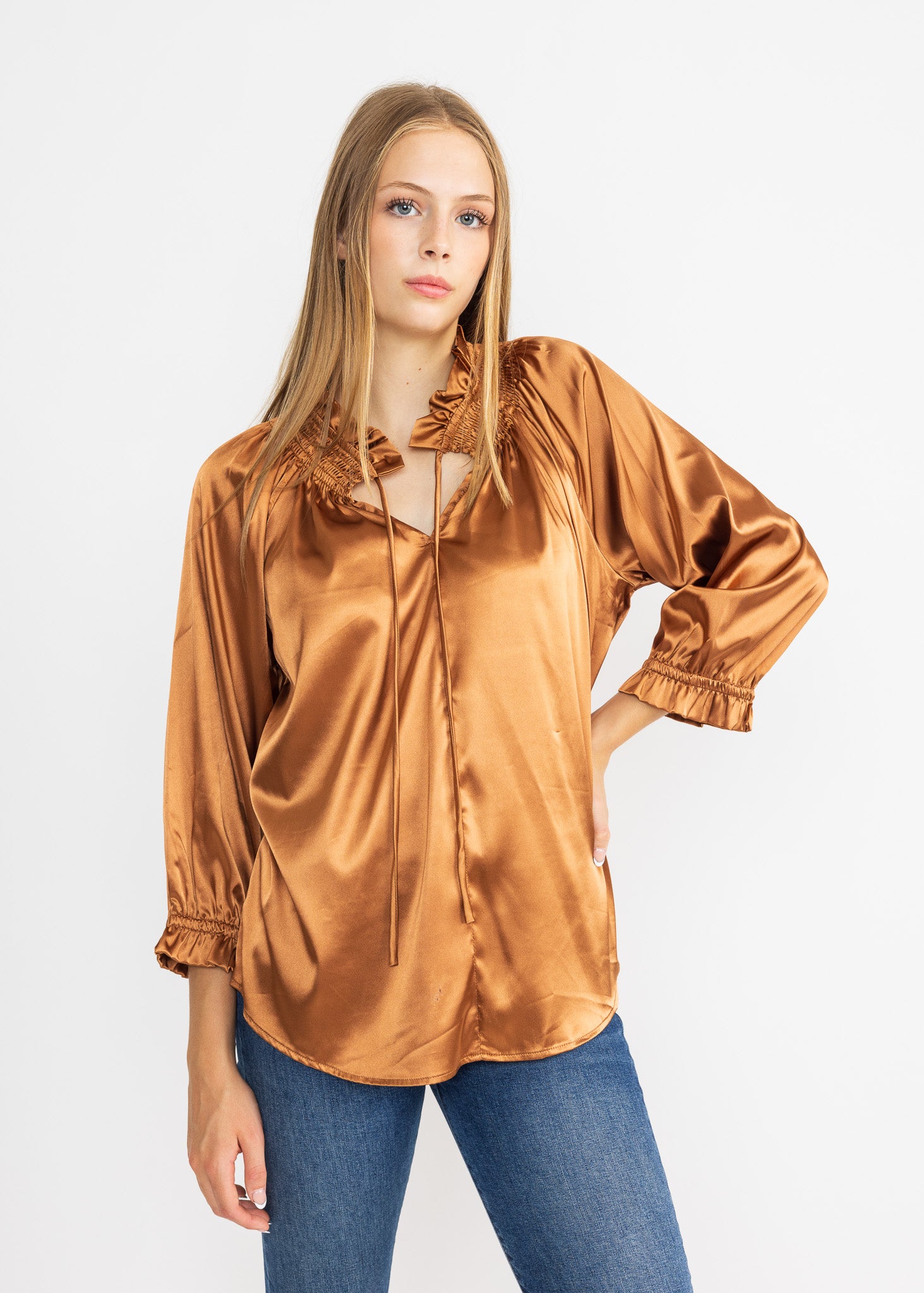 Elegant satin blouse with smocked details and a sophisticated style.