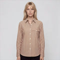 Woman wearing a brown striped shirt on a white background