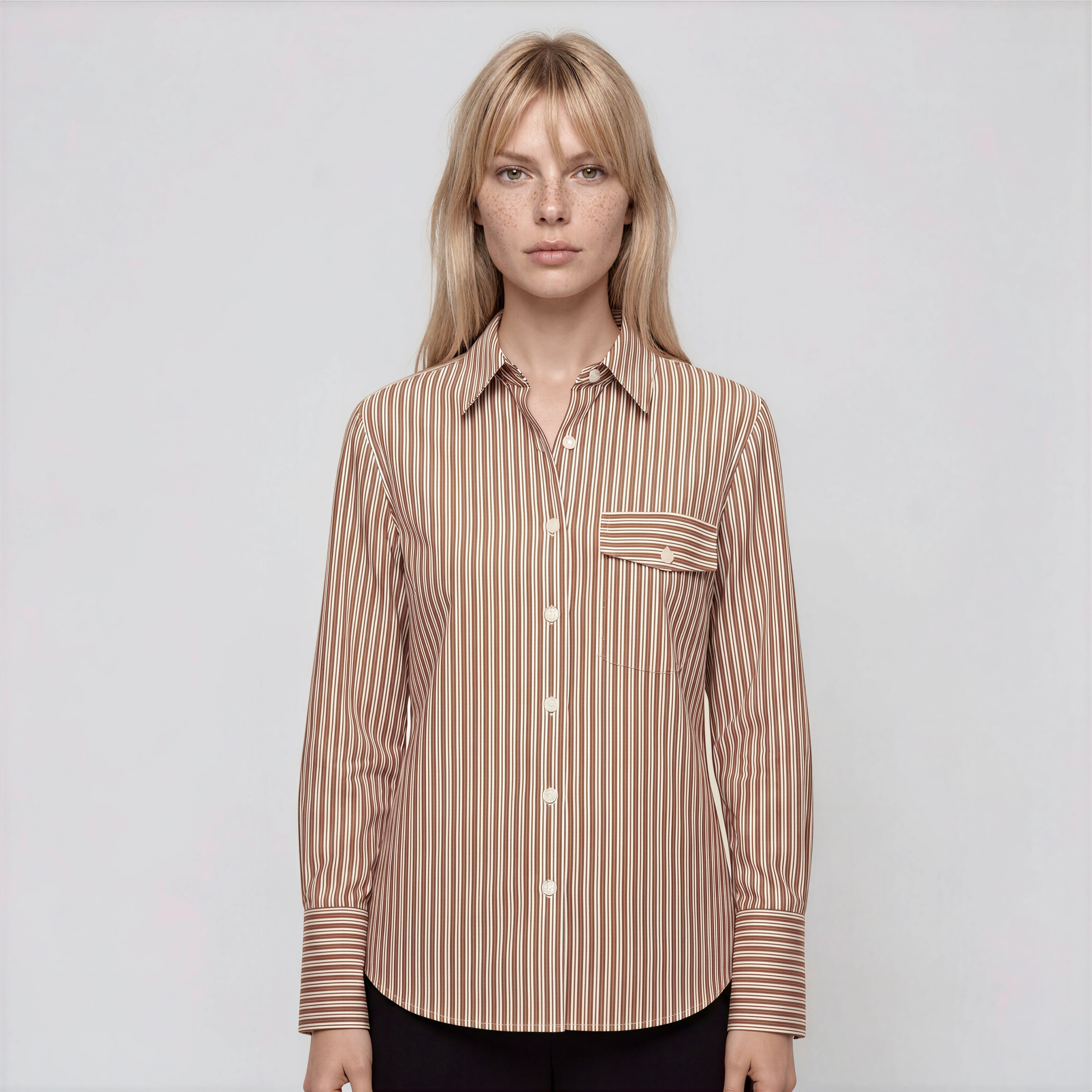 Woman wearing a brown striped shirt on a white background